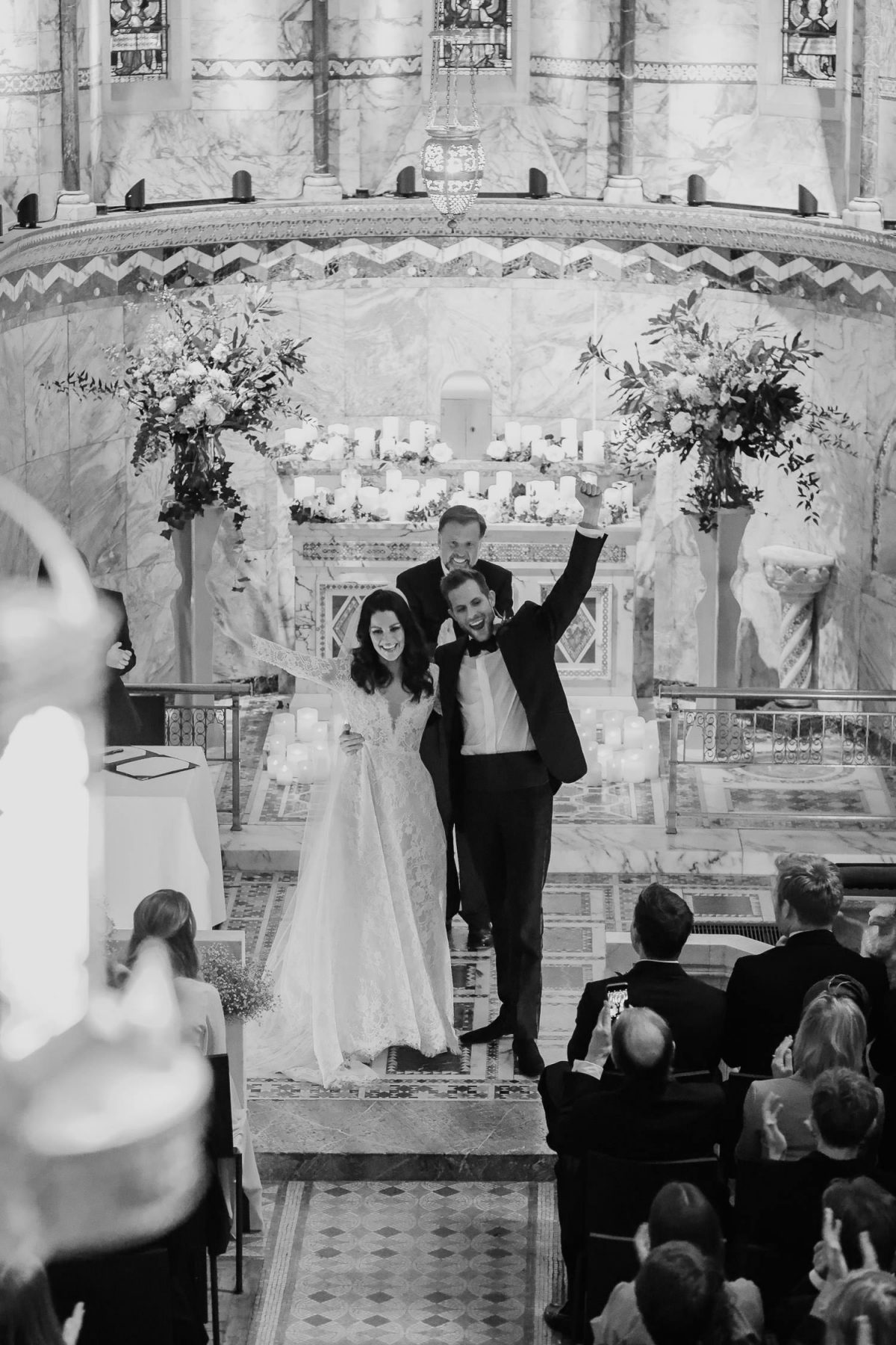 bride and groom standing by altar of fitzrovia chapel wedding