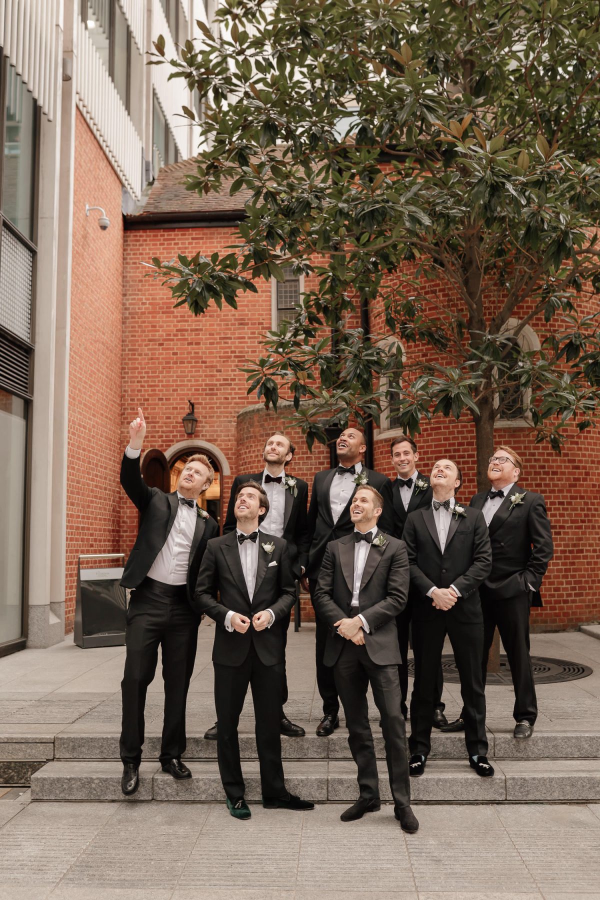 groom and groomsman waiting in front of the fitzrovia chapel for bride to arrive